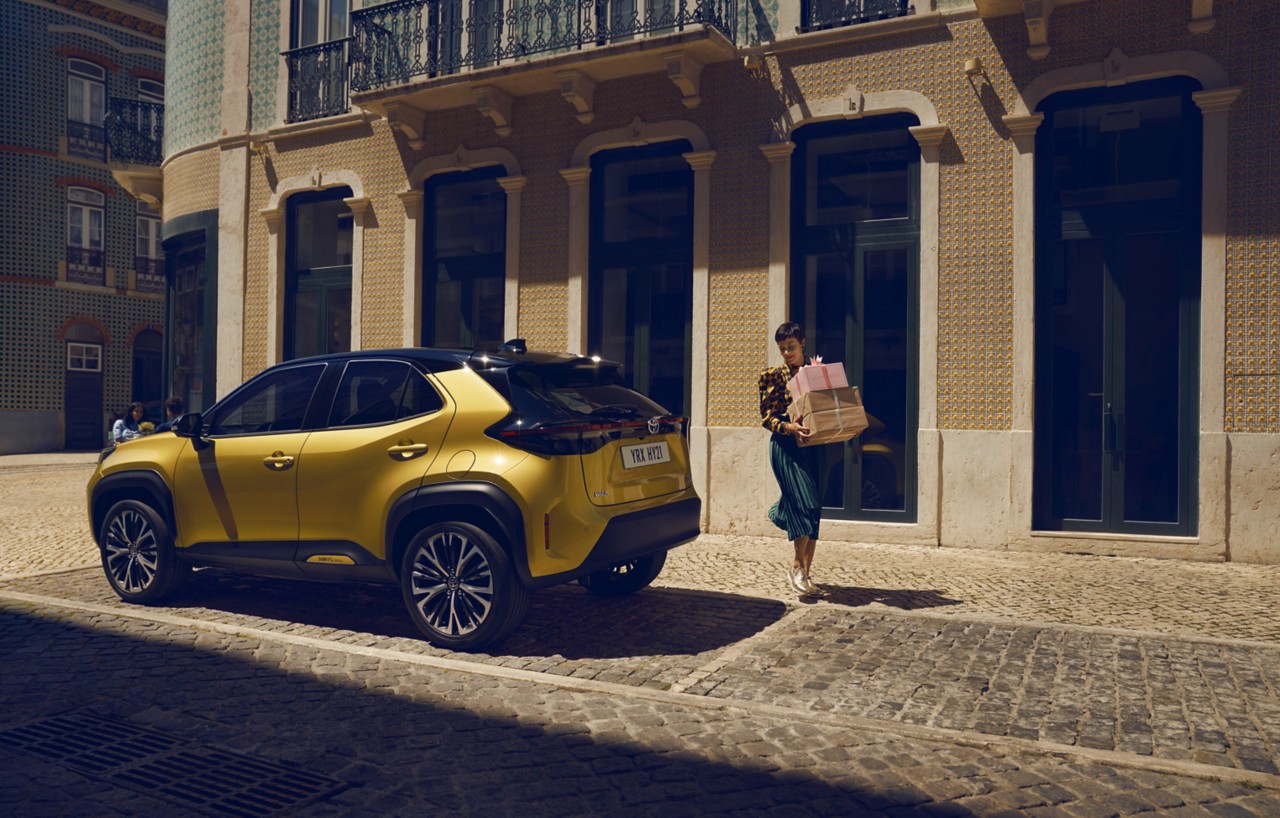 Toyota Corolla Hatchback driving down the road